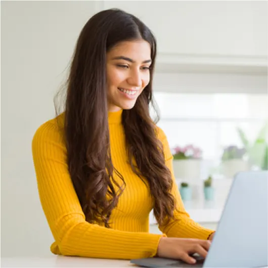 Smiling woman applying for a loan on her laptop